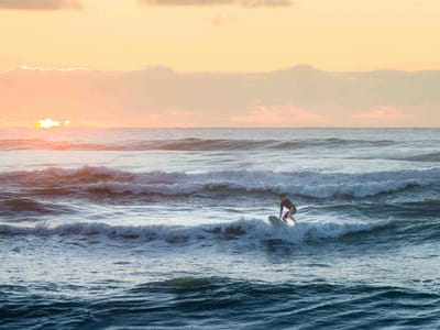 Pancake Rocks and Punakaiki Beach: Surfer off Punakaiki Beach