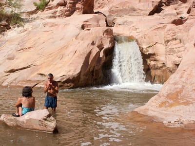 Fremont River Waterfall - Capitol Reef National Park: Mom and Dad by waterfall - TJG