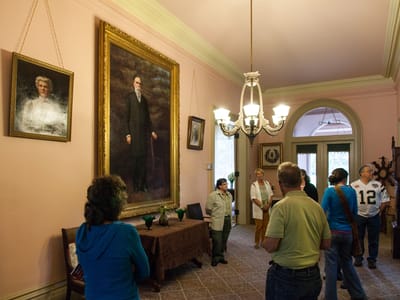 Bidwell Mansion State Historic Park: John and Annie Bidwell Portraits in Foyer with Tour Group