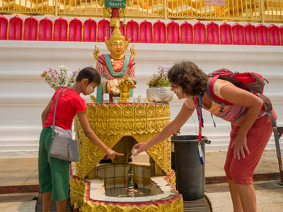Chiang Rai: Lolo's little friend helping her through her Buddhist rituals