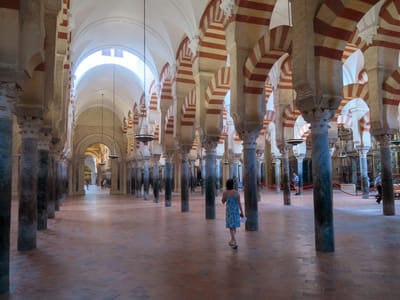 Cordoba and the Mezquita: Lolo wandering along the forest of Islamic red-and-white arches