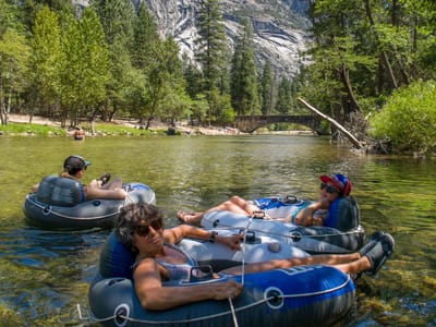 Yosemite Valley: The ladies being pulled behind the raft on our trip down the Merced