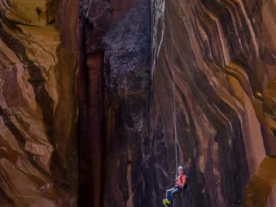 Moab: Rappeller descending from top of Morning Glory Natural Bridge