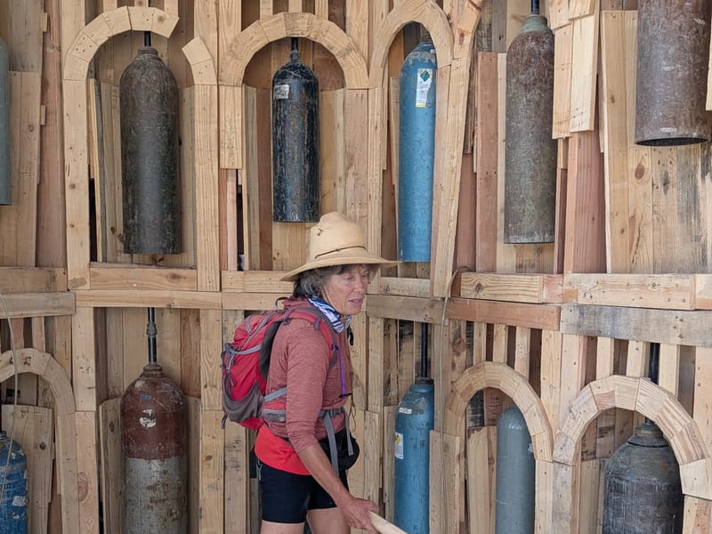 Striking the bells in the pavilion beneath The Man