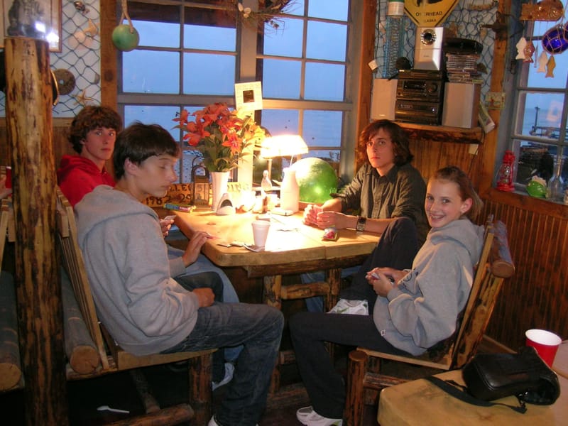 Kids playing cards in Miller's Landing lodge