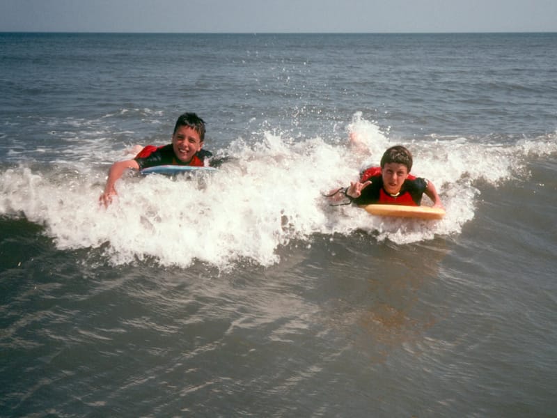 Boys boogie boarding Hunting Island