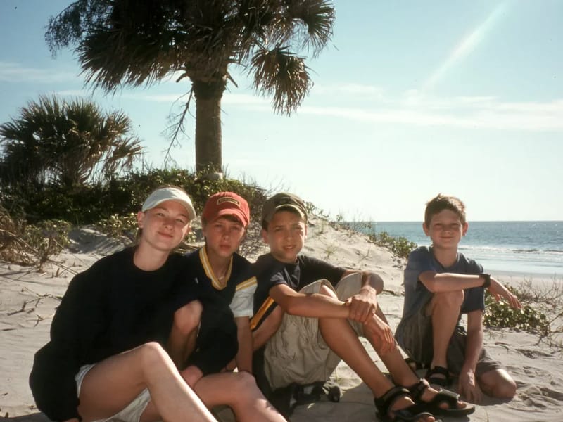 Kids under Palmetto Palm on beach