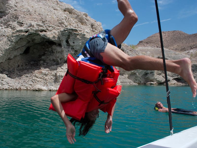 Andrew diving off boat with many preservers - TJG