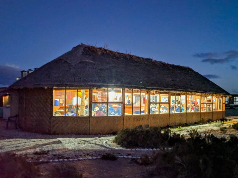 Campers gathered for dinner in cozy palapa