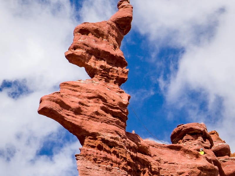 Climber atop the corkscrew summit of the Ancient Art formation
