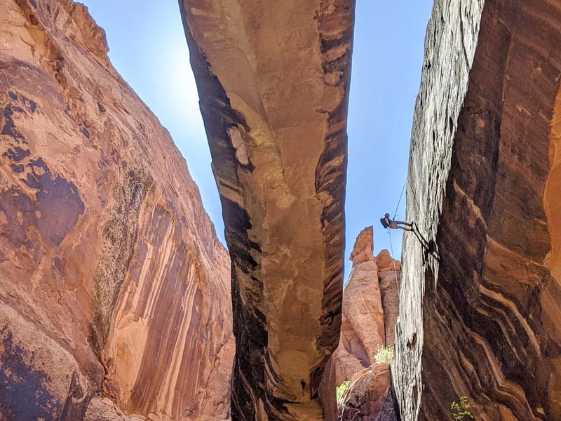 Rappeller descending from top of Morning Glory Natural Bridge